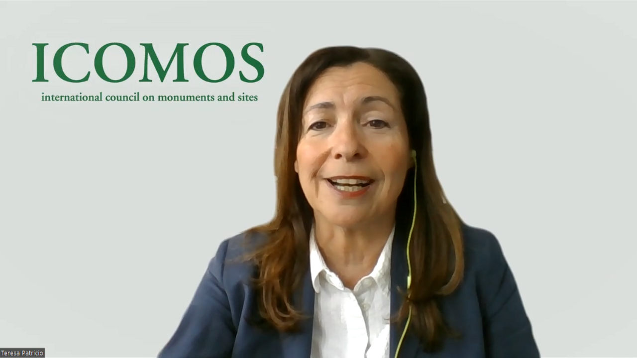 Zoom meeting screenshot of a woman speaking in front of a white background with the icomos logo in the top left corner.